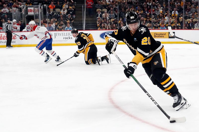 Feb 22, 2024; Pittsburgh, Pennsylvania, USA; Pittsburgh Penguins center Lars Eller (20) skates to clear the puck  the Montreal Canadiens during the second period at PPG Paints Arena. The Penguins won 4-1. Mandatory Credit: Charles LeClaire-USA TODAY Sports