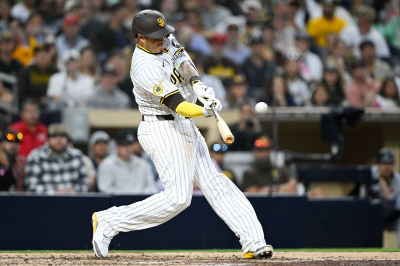 May 26, 2025; San Diego, California, USA; San Diego Padres third baseman Manny Machado (13) hits a solo home run during the eighth inning against the Miami Marlins at Petco Park. Mandatory Credit: Denis Poroy-Imagn Images