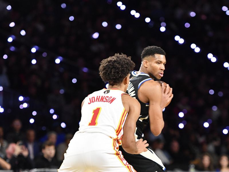 LAS VEGAS, NV - DECEMBER 14: Giannis Antetokounmpo #34 of the Milwaukee Bucks handles the ball while Jalen Johnson #1 of the Atlanta Hawks plays defense during the game during the Emirates NBA Cup Eastern Semifinals on December 14, 2024 at the T-Mobile Arena in Las Vegas, Nevada. NOTE TO USER: User expressly acknowledges and agrees that, by downloading and or using this photograph, User is consenting to the terms and conditions of the Getty Images License Agreement. Mandatory Copyright Notice: Copyright 2024 NBAE (Photo by Logan Riely/NBAE via Getty Images)