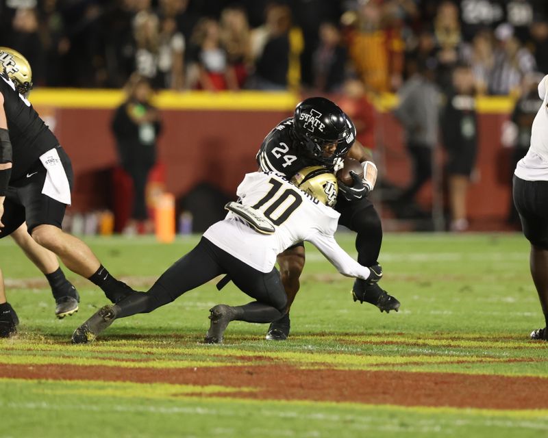 Oct 19, 2024; Ames, Iowa, USA;  Iowa State Cyclones running back Abu Sama III (24) is tackled by UCF Knights defensive back Quadric Bullard (10) at Jack Trice Stadium. Mandatory Credit: Reese Strickland-Imagn Images