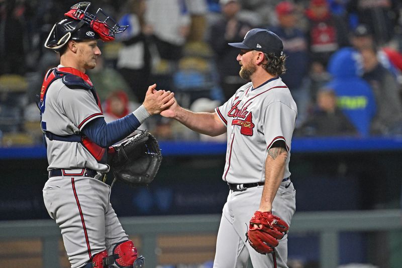 Apr 15, 2023; Kansas City, Missouri, USA;  Atlanta Braves relief pitcher Kirby Yates (right) shakes hands with catcher Sean Murphy (left) after defeating the Kansas City Royals at Kauffman Stadium. Mandatory Credit: Peter Aiken-USA TODAY Sports