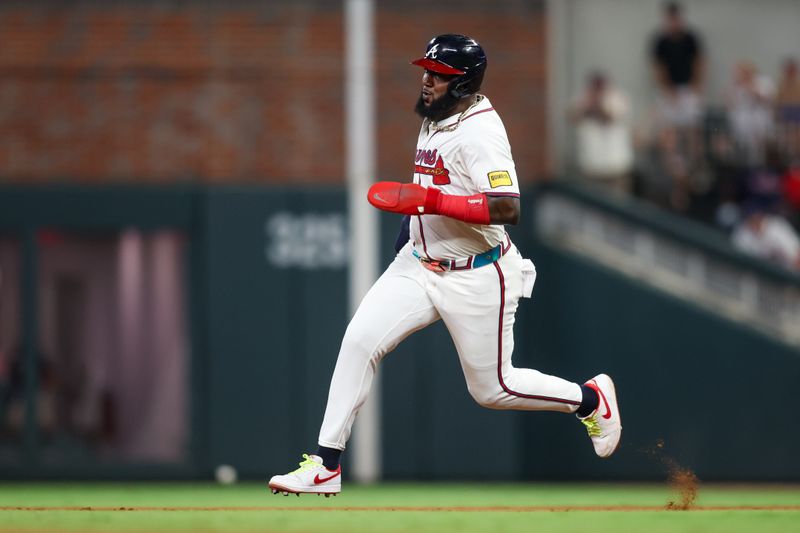 Aug 7, 2024; Atlanta, Georgia, USA; Atlanta Braves designated hitter Marcell Ozuna (20) runs to third against the Milwaukee Brewers in the fifth inning at Truist Park. Mandatory Credit: Brett Davis-USA TODAY Sports
