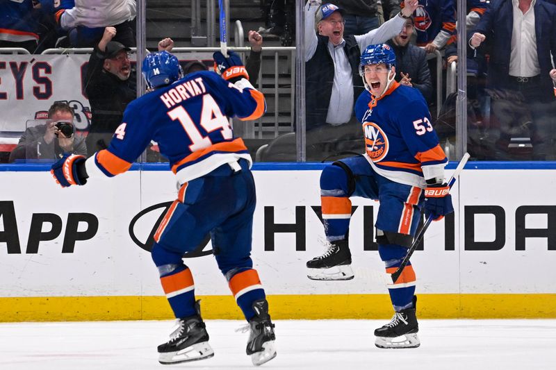 Apr 11, 2024; Elmont, New York, USA; New York Islanders center Casey Cizikas (53) celebrates his goal against the Montreal Canadiens with New York Islanders center Bo Horvat (14) during the third period at UBS Arena. Mandatory Credit: Dennis Schneidler-USA TODAY Sports