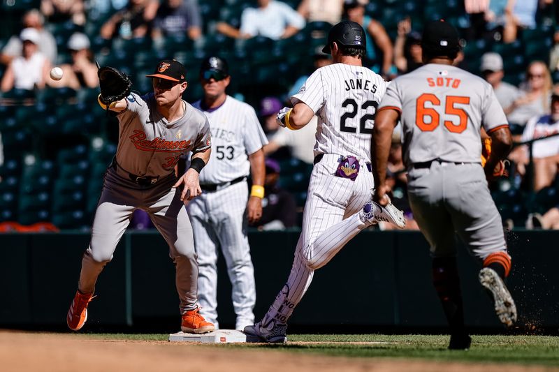 Sep 1, 2024; Denver, Colorado, USA; Colorado Rockies designated hitter Nolan Jones (22) beats the throw to Baltimore Orioles first baseman Ryan O'Hearn (32) as relief pitcher Gregory Soto (65) looks on in the ninth inning at Coors Field. Mandatory Credit: Isaiah J. Downing-USA TODAY Sports
