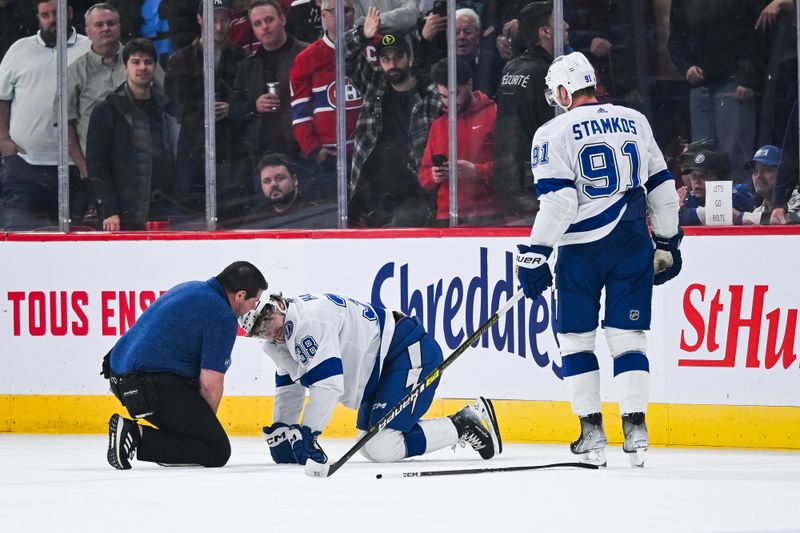 Apr 4, 2024; Montreal, Quebec, CAN; Tampa Bay Lightning left wing Brandon Hagel (38) receives medical help after colliding with center Steven Stamkos (91) against the Montreal Canadiens during the third period at Bell Centre. Mandatory Credit: David Kirouac-USA TODAY Sports