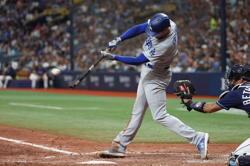 May 27, 2023; St. Petersburg, Florida, USA; Los Angeles Dodgers first baseman Freddie Freeman (5) hits an RBI double during the seventh inning against the Tampa Bay Rays at Tropicana Field. Mandatory Credit: Kim Klement-USA TODAY Sports