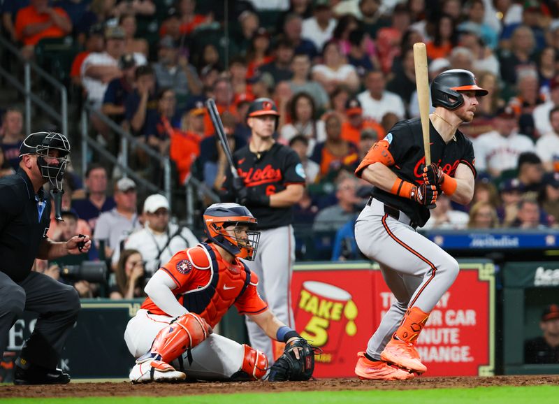 Jun 21, 2024; Houston, Texas, USA; Baltimore Orioles left fielder Ryan O'Hearn (32) hits a RBI sacrifice against the Houston Astros in the third inning at Minute Maid Park. Mandatory Credit: Thomas Shea-USA TODAY Sports