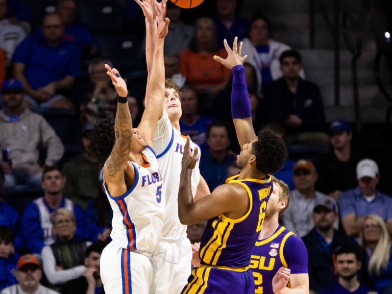 Feb 13, 2024; Gainesville, Florida, USA; Florida Gators guard Will Richard (5) and Florida Gators center Micah Handlogten (3) attempt to block a shot from LSU Tigers guard Jordan Wright (6) during the second half at Exactech Arena at the Stephen C. O'Connell Center. Mandatory Credit: Matt Pendleton-USA TODAY Sports