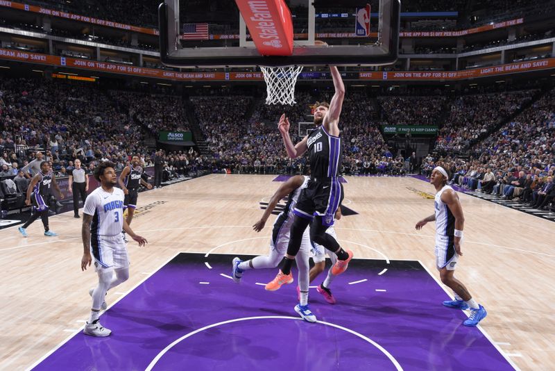 SACRAMENTO, CA - JANUARY 3: Domantas Sabonis #10 of the Sacramento Kings dunks the ball during the game against the Orlando Magic on January 3, 2024 at Golden 1 Center in Sacramento, California. NOTE TO USER: User expressly acknowledges and agrees that, by downloading and or using this Photograph, user is consenting to the terms and conditions of the Getty Images License Agreement. Mandatory Copyright Notice: Copyright 2024 NBAE (Photo by Rocky Widner/NBAE via Getty Images)