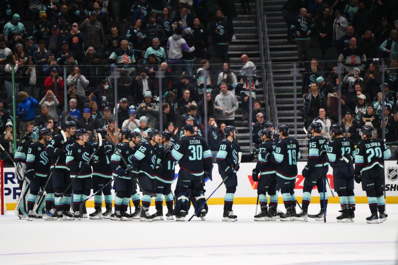 Nov 12, 2024; Seattle, Washington, USA; The Seattle Kraken celebrate after defeating the Columbus Blue Jackets at Climate Pledge Arena. Mandatory Credit: Steven Bisig-Imagn Images