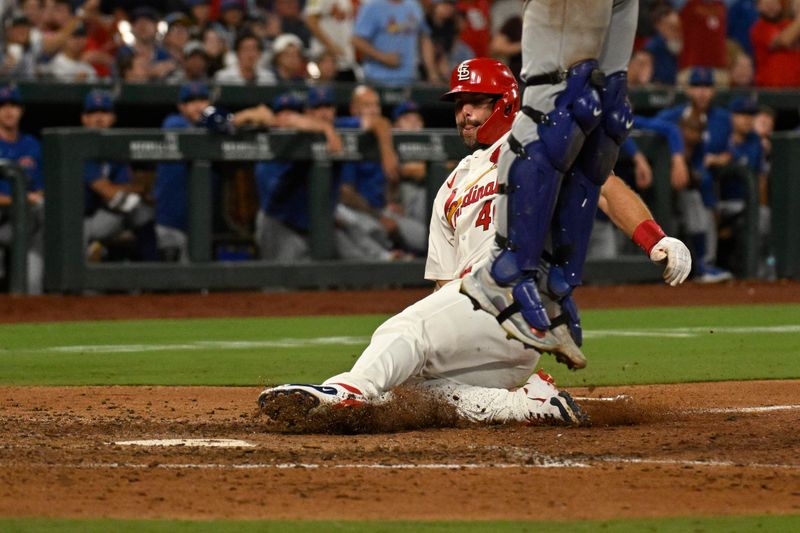 Jul 13, 2024; St. Louis, Missouri, USA; St. Louis Cardinals first baseman Paul Goldschmidt (46) slides into home to score off a single from third baseman Nolan Arenado (not pictured) against the Chicago Cubs during the eighth inning at Busch Stadium. Mandatory Credit: Jeff Le-USA TODAY Sports