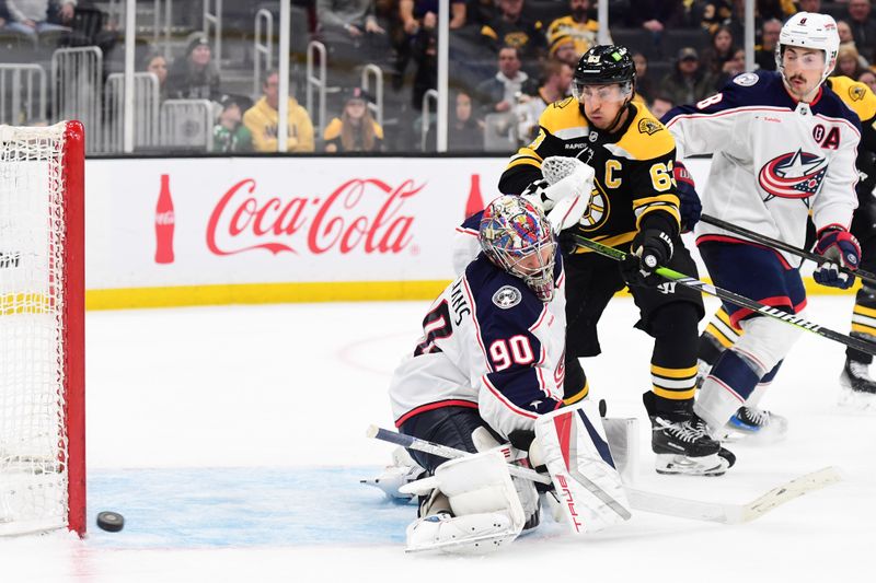 Nov 18, 2024; Boston, Massachusetts, USA;  Boston Bruins left wing Brad Marchand (63) watches the puck go wide of Columbus Blue Jackets goaltender Elvis Merzlikins (90) during the third period at TD Garden. Mandatory Credit: Bob DeChiara-Imagn Images