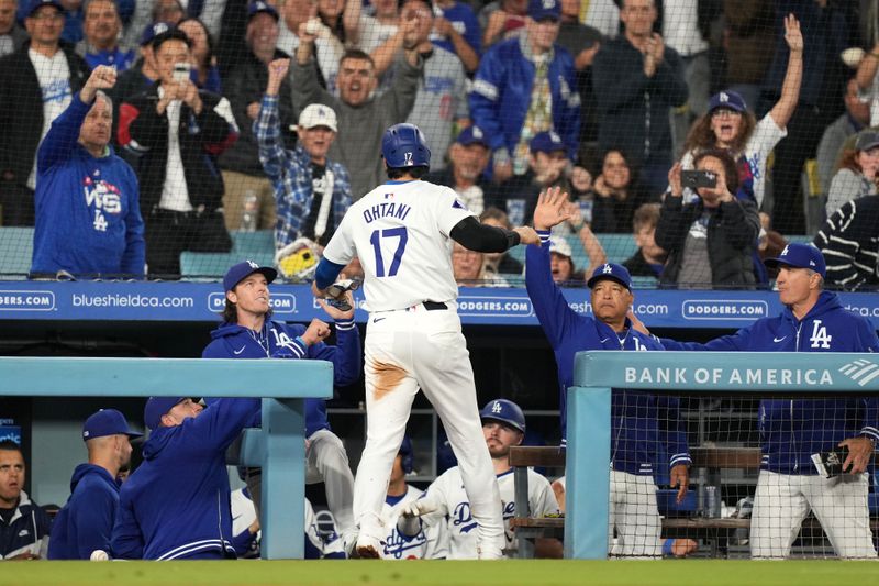 May 21, 2024; Los Angeles, California, USA; Los Angeles Dodgers designated hitter Shohei Ohtani (17) celebrates with manager Dave Roberts after scoring in the fourth inning against the Arizona Diamondbacks at Dodger Stadium. Mandatory Credit: Kirby Lee-USA TODAY Sports