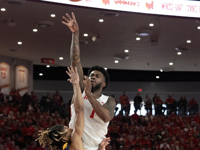 Jan 6, 2024; Houston, Texas, USA; Houston Cougars guard Jamal Shead (1) shoots against West Virginia Mountaineers guard Noah Farrakhan (1) in the first half  at Fertitta Center. Mandatory Credit: Thomas Shea-USA TODAY Sports