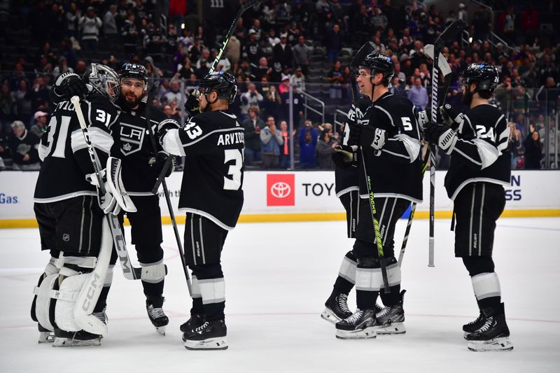 Mar 20, 2024; Los Angeles, California, USA; Los Angeles Kings goaltender David Rittich (31) and defenseman Drew Doughty (8) celebrate the victory against the Minnesota Wild at Crypto.com Arena. Mandatory Credit: Gary A. Vasquez-USA TODAY Sports