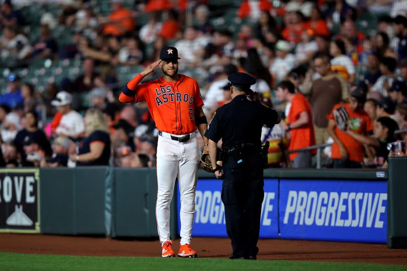 Sep 19, 2025; Houston, Texas, USA; Houston Astros shortstop Jeremy Pena (3) salutes a police officer on the field prior to the game against the Seattle Mariners at Daikin Park. Mandatory Credit: Erik Williams-Imagn Images