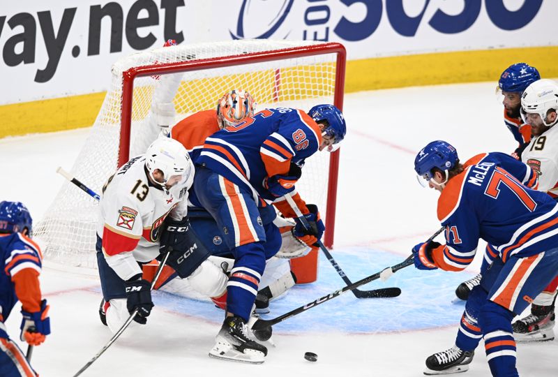 June 21, 2024; Edmonton, Alberta, CAN; Edmonton Oilers defenseman Philip Broberg (86) and Edmonton Oilers center Ryan McLeod (71) work to clear the puck away from Florida Panthers center Sam Reinhart (13) in the second period in game six of the 2024 Stanley Cup Final at Rogers Place. Mandatory Credit: Walter Tychnowicz-USA TODAY Sports