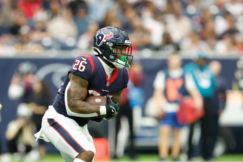 Houston Texans running back Royce Freeman (26) carries the ball during an NFL football game against the Jacksonville Jaguars on Sunday, January 1, 2023, in Houston. (AP Photo/Matt Patterson)