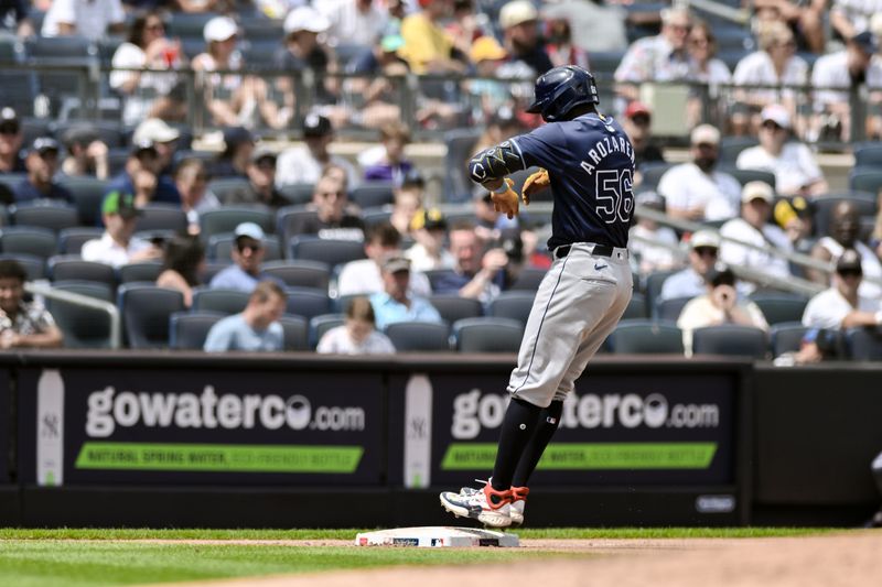 Jul 21, 2024; Bronx, New York, USA; Tampa Bay Rays outfielder Randy Arozarena (56) leaps onto third base after hitting a solo home run against the New York Yankees during the fourth inning at Yankee Stadium. Mandatory Credit: John Jones-USA TODAY Sports