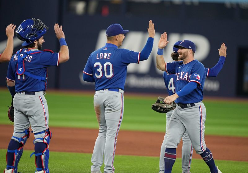 Sep 13, 2023; Toronto, Ontario, CAN; Texas Rangers right fielder Robbie Grossman (4) celebrates the win with first baseman Nathaniel Lowe (30) against the Toronto Blue Jays at the end of the ninth inning at Rogers Centre. Mandatory Credit: Nick Turchiaro-USA TODAY Sports