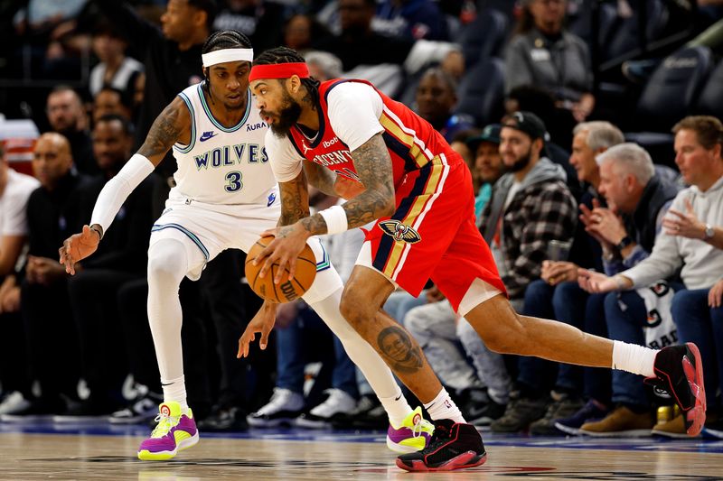 MINNEAPOLIS, MINNESOTA - JANUARY 03: Brandon Ingram #14 of the New Orleans Pelicans drives to the basket while Jaden McDaniels #3 of the Minnesota Timberwolves defends in the fourth quarter at Target Center on January 03, 2024 in Minneapolis, Minnesota. The Pelicans defeated the Timberwolves 117-106. NOTE TO USER: User expressly acknowledges and agrees that, by downloading and or using this photograph, User is consenting to the terms and conditions of the Getty Images License Agreement. (Photo by David Berding/Getty Images)