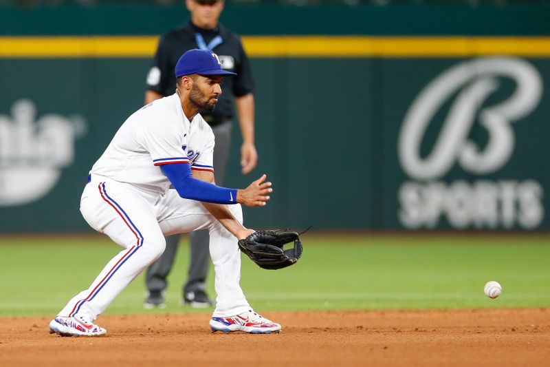 Aug 2, 2023; Arlington, Texas, USA; Texas Rangers second baseman Marcus Semien (2) fields a ground ball during the fifth inning against the Chicago White Sox at Globe Life Field. Mandatory Credit: Andrew Dieb-USA TODAY Sports