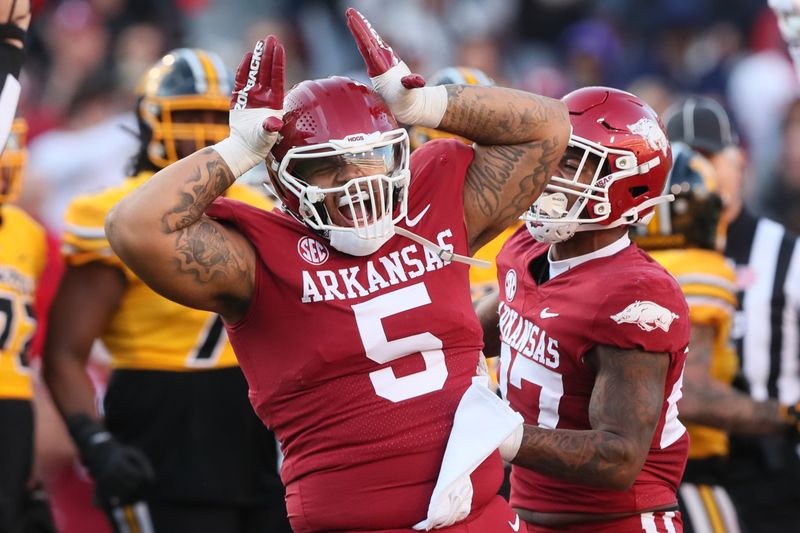 Nov 24, 2023; Fayetteville, Arkansas, USA; Arkansas Razorbacks defensive lineman Cameron Ball (5) celebrates after a tackle in the first quarter against the Missouri Tigers at Donald W. Reynolds Razorback Stadium. Mandatory Credit: Nelson Chenault-USA TODAY Sports