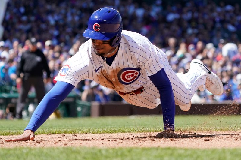 May 5, 2024; Chicago, Illinois, USA; Chicago Cubs third base Christopher Morel (5) dives into first base against the Milwaukee Brewers during the fourth inning at Wrigley Field. Mandatory Credit: David Banks-USA TODAY Sports
