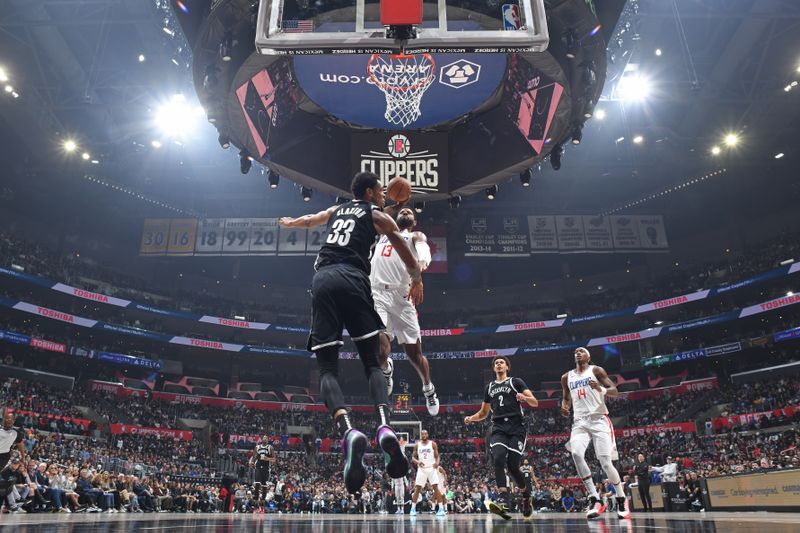 LOS ANGELES, CA - JANUARY 21: Paul George #13 of the LA Clippers dunks the ball during the game against the Brooklyn Nets on January 21, 2024 at Crypto.Com Arena in Los Angeles, California. NOTE TO USER: User expressly acknowledges and agrees that, by downloading and/or using this Photograph, user is consenting to the terms and conditions of the Getty Images License Agreement. Mandatory Copyright Notice: Copyright 2024 NBAE (Photo by Adam Pantozzi/NBAE via Getty Images)