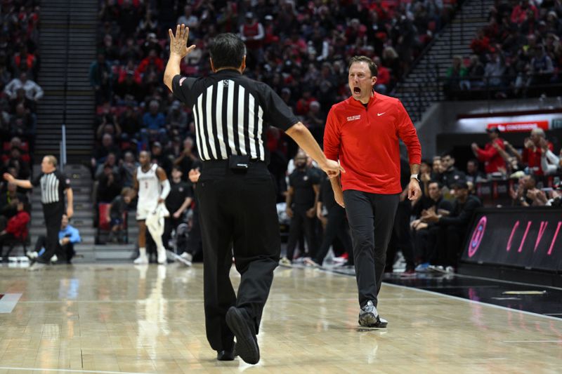 Jan 14, 2023; San Diego, California, USA; New Mexico Lobos head coach Richard Pitino (right) reacts toward an official during the second half against the San Diego State Aztecs at Viejas Arena. Mandatory Credit: Orlando Ramirez-USA TODAY Sports