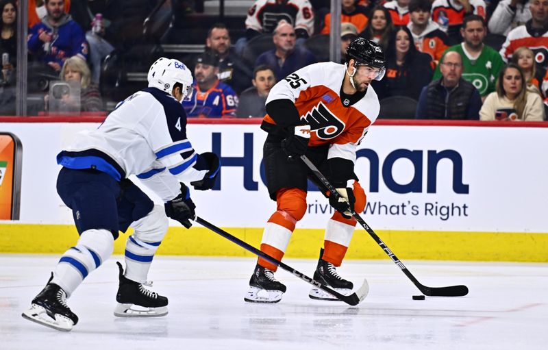 Feb 8, 2024; Philadelphia, Pennsylvania, USA; Philadelphia Flyers center Ryan Poehling (25) controls the puck against Winnipeg Jets defenseman Neal Pionk (4) in the first period at Wells Fargo Center. Mandatory Credit: Kyle Ross-USA TODAY Sports