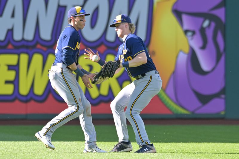 Jun 24, 2023; Cleveland, Ohio, USA; Milwaukee Brewers left fielder Christian Yelich (22) and center fielder Joey Wiemer (28) nearly collide while fielding an RBI hit by Cleveland Guardians second baseman Andres Gimenez (not pictured) during the eighth inning at Progressive Field. Mandatory Credit: Ken Blaze-USA TODAY Sports