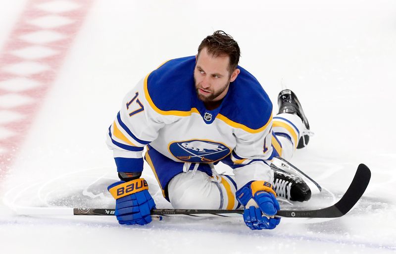 Oct 16, 2024; Pittsburgh, Pennsylvania, USA;  Buffalo Sabres left wing Jason Zucker (17) stretches on the ice to warm up before the game against the Pittsburgh Penguins at PPG Paints Arena. Mandatory Credit: Charles LeClaire-Imagn Images