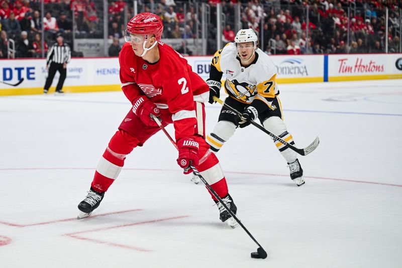 Oct 10, 2024; Detroit, Michigan, USA; Detroit Red Wings defenseman Olli Maatta (2) brings the puck up ice against Pittsburgh Penguins left wing Anthony Beauvillier (72) during the game at Little Caesars Arena. Mandatory Credit: Tim Fuller-Imagn Images