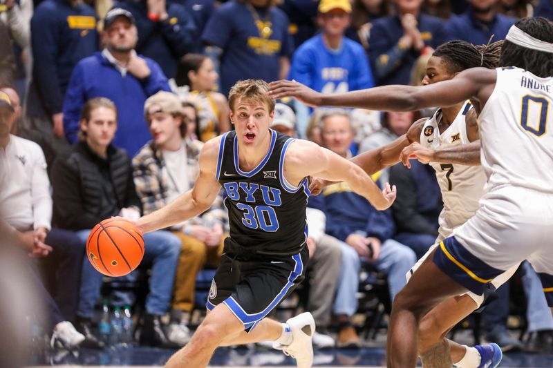 Feb 11, 2025; Morgantown, West Virginia, USA; Brigham Young Cougars guard Dallin Hall (30) drives past West Virginia Mountaineers guard Javon Small (7) during the second half at WVU Coliseum. Mandatory Credit: Ben Queen-Imagn Images