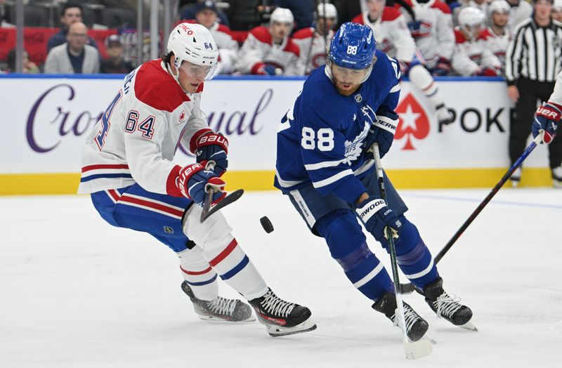 Sep 26, 2024; Toronto, Ontario, CAN;  Toronto Maple Leafs forward William Nylander (88) battles for the puck with Montreak Canadiens defenseman David Reinbacher (64) in the first period at Scotiabank Arena. Mandatory Credit: Dan Hamilton-Imagn Images