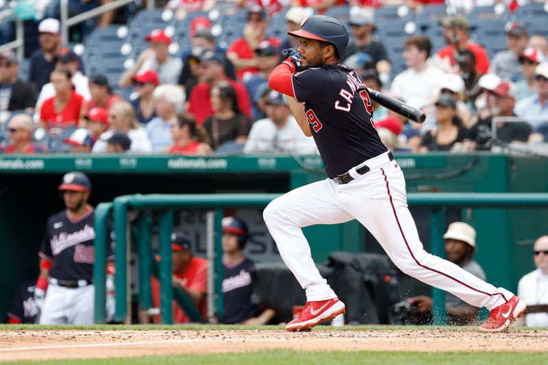 Jul 9, 2023; Washington, District of Columbia, USA; Washington Nationals third baseman Jeimer Candelario (9) singles against the Texas Rangers during the fourth inningat Nationals Park. Mandatory Credit: Geoff Burke-USA TODAY Sports