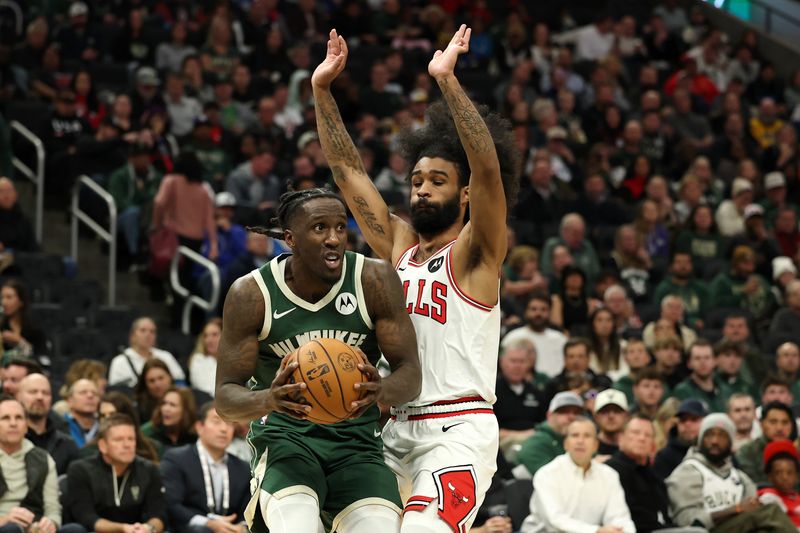 MILWAUKEE, WISCONSIN - NOVEMBER 20: Taurean Prince #12 of the Milwaukee Bucks is defended by Coby White #0 of the Chicago Bulls during the second half of a game at Fiserv Forum on November 20, 2024 in Milwaukee, Wisconsin. NOTE TO USER: User expressly acknowledges and agrees that, by downloading and or using this photograph, User is consenting to the terms and conditions of the Getty Images License Agreement. (Photo by Stacy Revere/Getty Images)