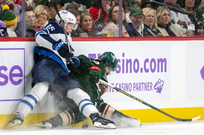 Nov 25, 2024; Saint Paul, Minnesota, USA;  Winnipeg Jets forward Rasmus Kupari (15) finishes his check on Minnesota Wild forward Marcus Johansson (90) during the third period at Xcel Energy Center. Mandatory Credit: Nick Wosika-Imagn Images