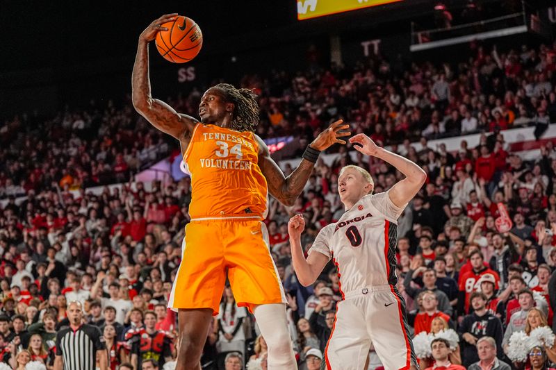 Jan 28, 2026; Athens, Georgia, USA; Tennessee Volunteers center Felix Okpara (34) controls a rebound over Georgia Bulldogs guard Blue Cain (0) at Stegeman Coliseum. Mandatory Credit: Dale Zanine-Imagn Images
