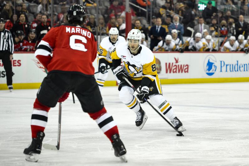 Apr 2, 2024; Newark, New Jersey, USA; Pittsburgh Penguins center Sidney Crosby (87) skates with the puck while being defended by New Jersey Devils defenseman John Marino (6) during the third period at Prudential Center. Mandatory Credit: John Jones-USA TODAY Sports