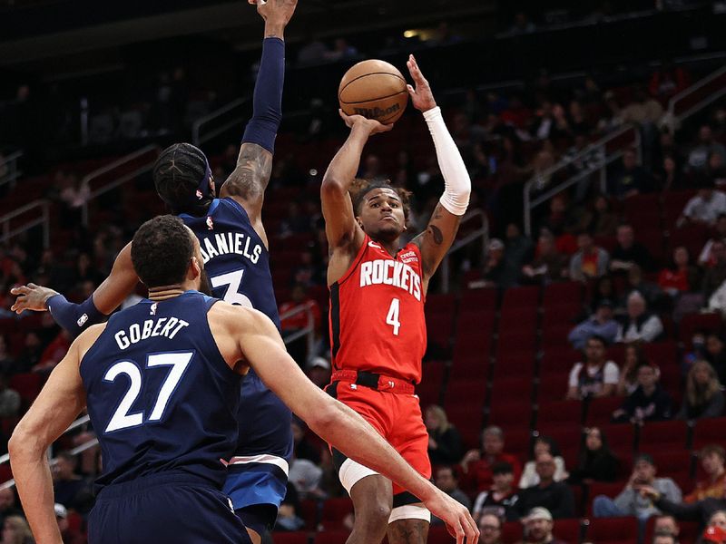 HOUSTON, TEXAS - JANUARY 23: Jalen Green #4 of the Houston Rockets shoots over Jaden McDaniels #3 of the Minnesota Timberwolves during the first quarter at Toyota Center on January 23, 2023 in Houston, Texas.  NOTE TO USER: User expressly acknowledges and agrees that, by downloading and or using this photograph, User is consenting to the terms and conditions of the Getty Images License Agreement. (Photo by Bob Levey/Getty Images)