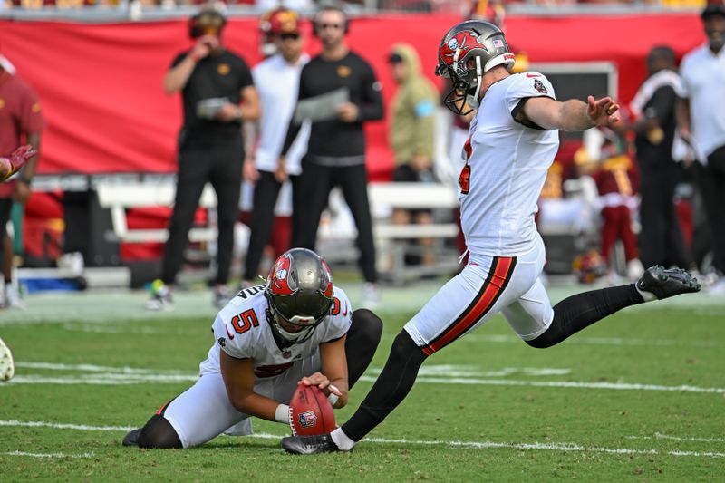 Tampa Bay Buccaneers place kicker Chase McLaughlin, right, kicks a field goal against the Washington Commanders during the first half of an NFL football game Sunday, Sept. 8, 2024, in Tampa, Fla. (AP Photo/Jason Behnken)