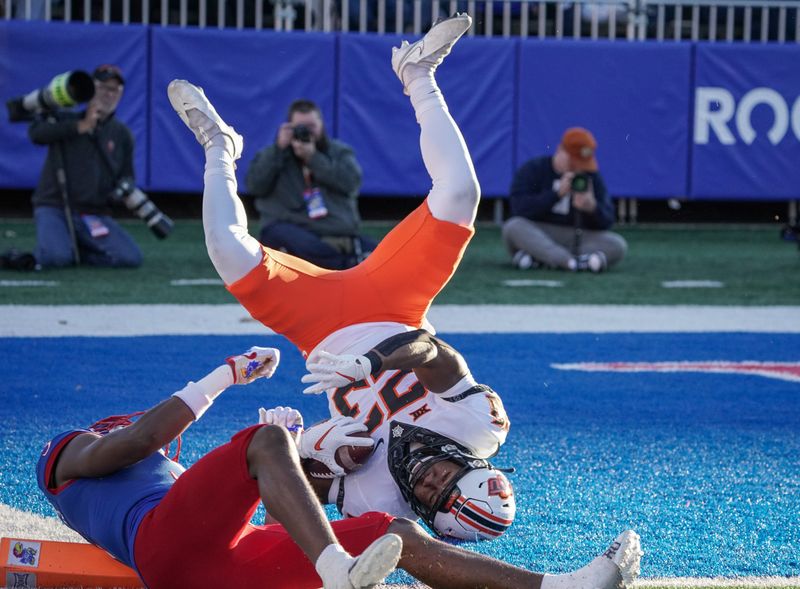 Nov 5, 2022; Lawrence, Kansas, USA; Oklahoma State Cowboys running back Jaden Nixon (23) scores a touchdown as Kansas Jayhawks safety O.J. Burroughs (5) misses the tackle during the second half of the game at David Booth Kansas Memorial Stadium. Mandatory Credit: Denny Medley-USA TODAY Sports