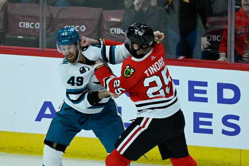 Jan 16, 2024; Chicago, Illinois, USA; San Jose Sharks right wing Scott Sabourin (49) and Chicago Blackhawks defenseman Jarred Tinordi (25) fight during the second period at United Center. Mandatory Credit: Matt Marton-USA TODAY Sports