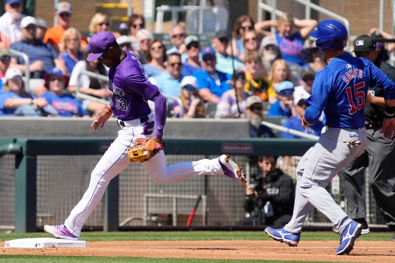 Mar 21, 2024; Salt River Pima-Maricopa, Arizona, USA; Colorado Rockies third baseman Julio Carreras (83) gets the force out on Chicago Cubs catcher Yan Gomes (15) in the third inning at Salt River Fields at Talking Stick. Mandatory Credit: Rick Scuteri-USA TODAY Sports