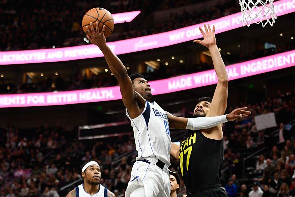 SALT LAKE CITY, UTAH - JANUARY 01: Brandon Williams #00 of the Dallas Mavericks shoots over Omer Yurtseven #77 of the Utah Jazz during the second half of a game at Delta Center on January 01, 2024 in Salt Lake City, Utah. NOTE TO USER: User expressly acknowledges and agrees that, by downloading and or using this photograph, User is consenting to the terms and conditions of the Getty Images License Agreement. (Photo by Alex Goodlett/Getty Images)