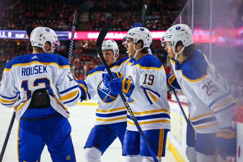 Mar 24, 2024; Calgary, Alberta, CAN; Buffalo Sabres center Peyton Krebs (19) celebrates his goal with teammates against the Calgary Flames during the first period at Scotiabank Saddledome. Mandatory Credit: Sergei Belski-USA TODAY Sports