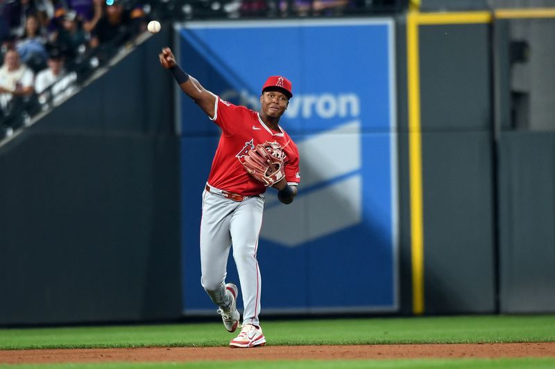 Sep 20, 2025; Denver, Colorado, USA; Los Angeles Angels catcher Logan O'Hoppe (14) throws the ball to first for an out during the fifth inning against the Colorado Rockies at Coors Field. Mandatory Credit: Christopher Hanewinckel-Imagn Images