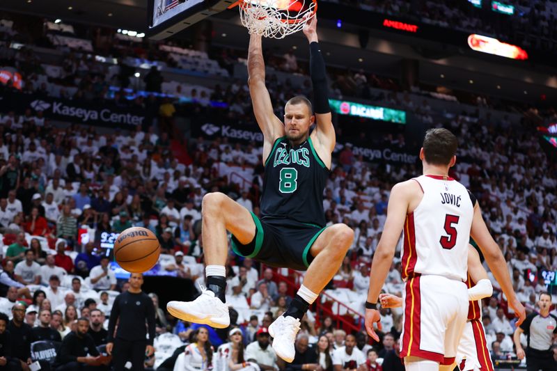 MIAMI, FLORIDA - APRIL 27: Kristaps Porzingis #8 of the Boston Celtics dunks the ball against the Miami Heat during the first quarter in game three of the Eastern Conference First Round Playoffs at Kaseya Center on April 27, 2024 in Miami, Florida.  NOTE TO USER: User expressly acknowledges and agrees that, by downloading and or using this photograph, User is consenting to the terms and conditions of the Getty Images License Agreement. (Photo by Megan Briggs/Getty Images)